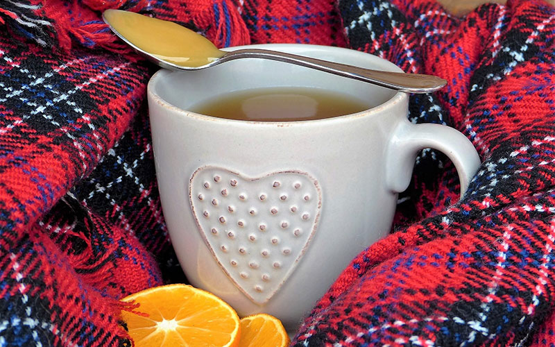Tea with a spoonful of honey and orange slices