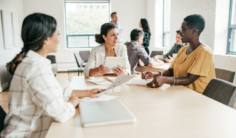 Coworkers collaborating at a table in the office