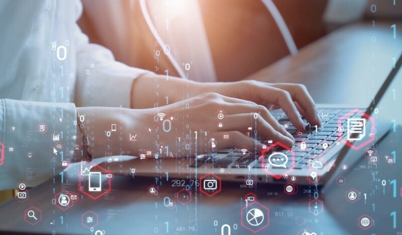 Person working at laptop with abstract imagery overlaid depicting icons that represent: chat, chart, phone, message, globe, signal, and email