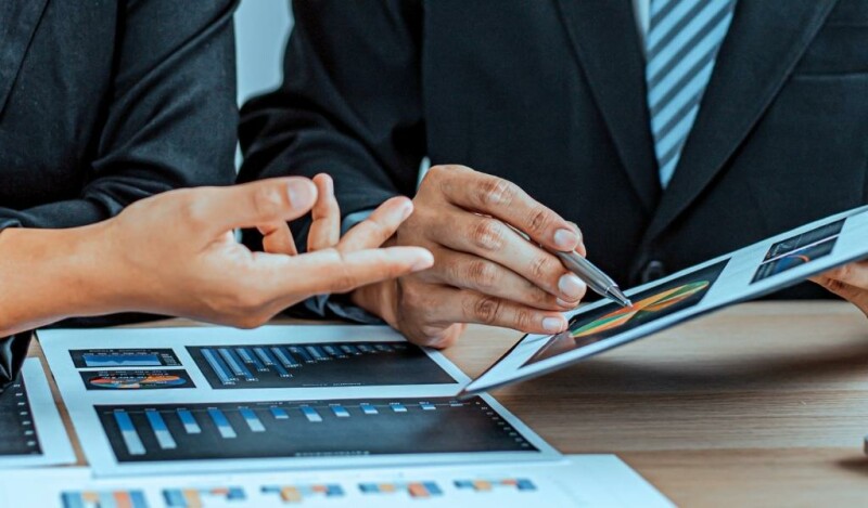 Coworkers looking at a graph on a tablet screen