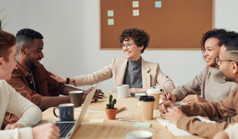 Colleagues smiling at each other during a meeting