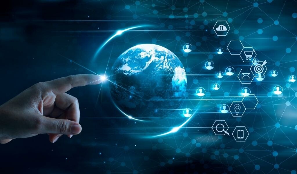 Abstract photo of a person pointing at a global view of earth with user icons floating around it