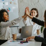 Colleagues in a meeting high-fiving