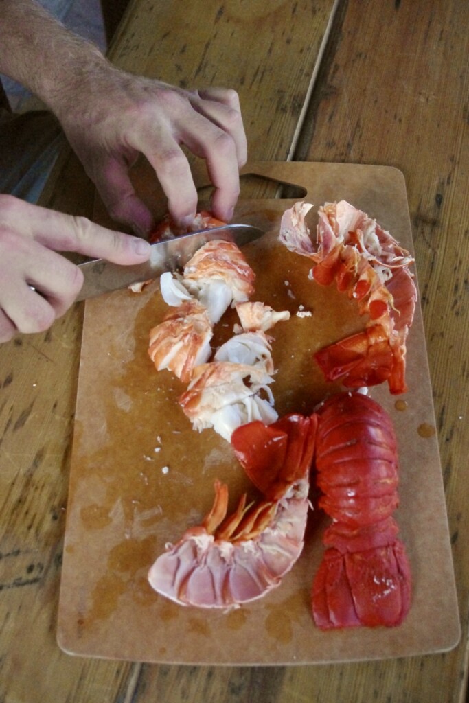 Chopped spiny lobster tail meat on a cutting board.