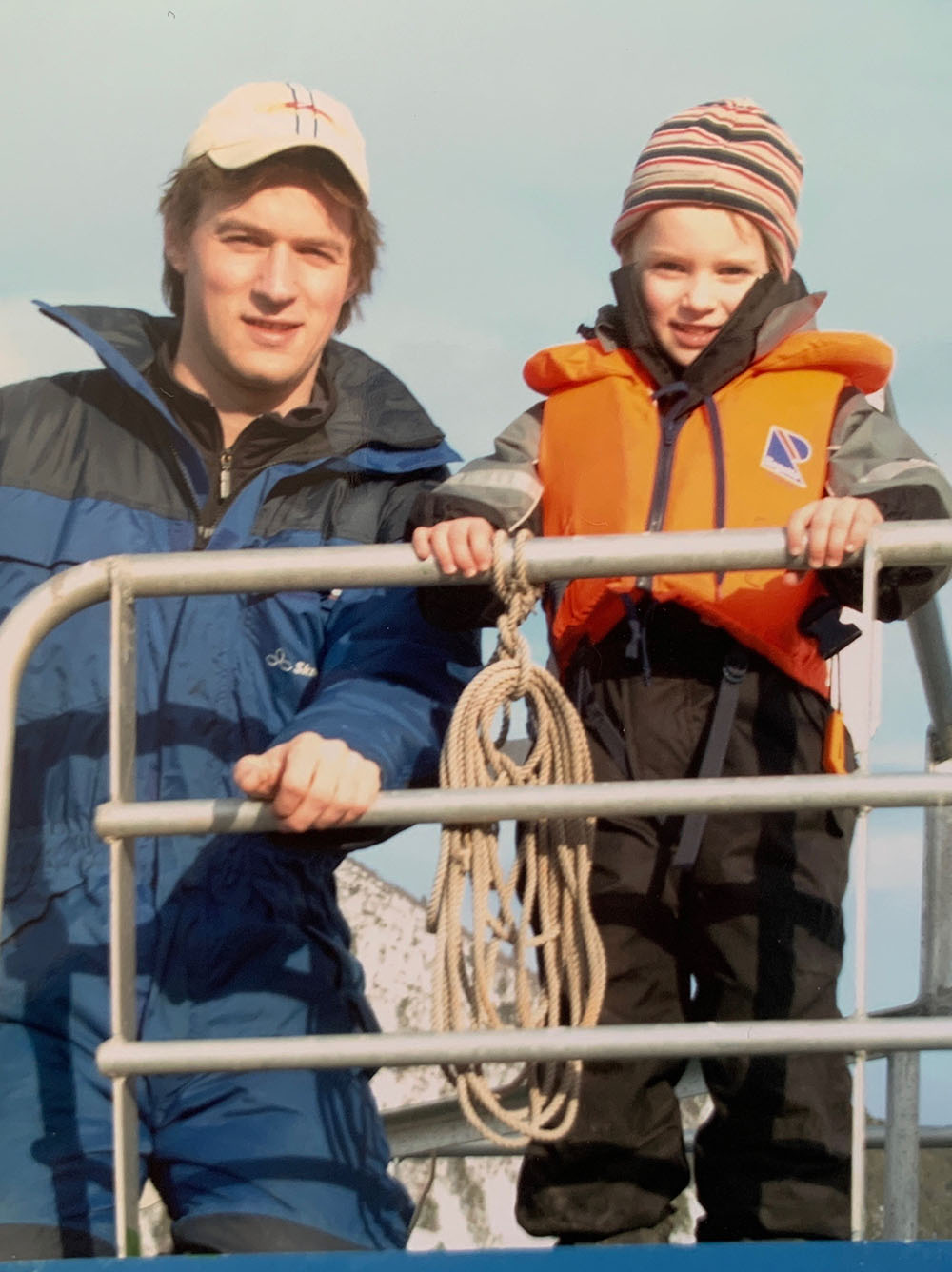 Johan Andreassen and a young Emil Andreassen on a salmon farm vessel