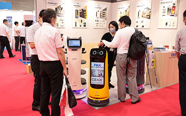 Column-shaped “robowaiters” made by Shenzhen, China-based Pudu Robotics.
