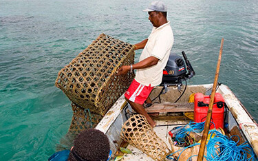 A man fishing on a boat in Seychelles