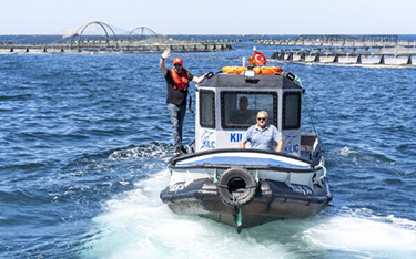 A boat touring a fish farm in the Mediterranean