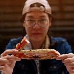 A restaurant-goer eating a king crab leg.