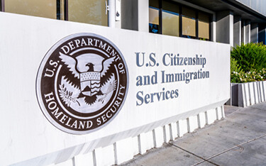 A photo of a U.S. Citizenship and Immigration Services building.