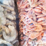 Bags of raw and cooked frozen shrimp.