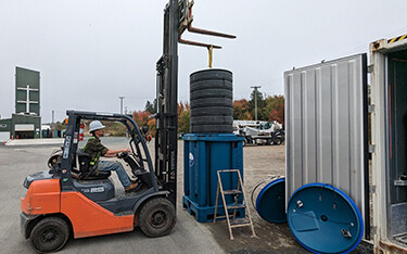 A photo of trays being loaded into a barrel at Ocean Perfect's facility.