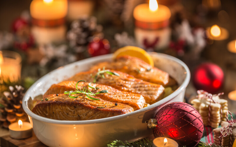 Salmon dish with a Christmas-themed background.