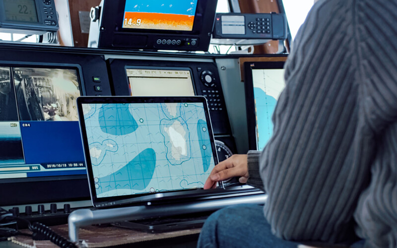 Captain monitoring GPS on vessel.