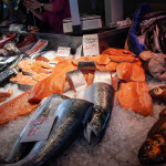 A pile of salmon in a marketplace