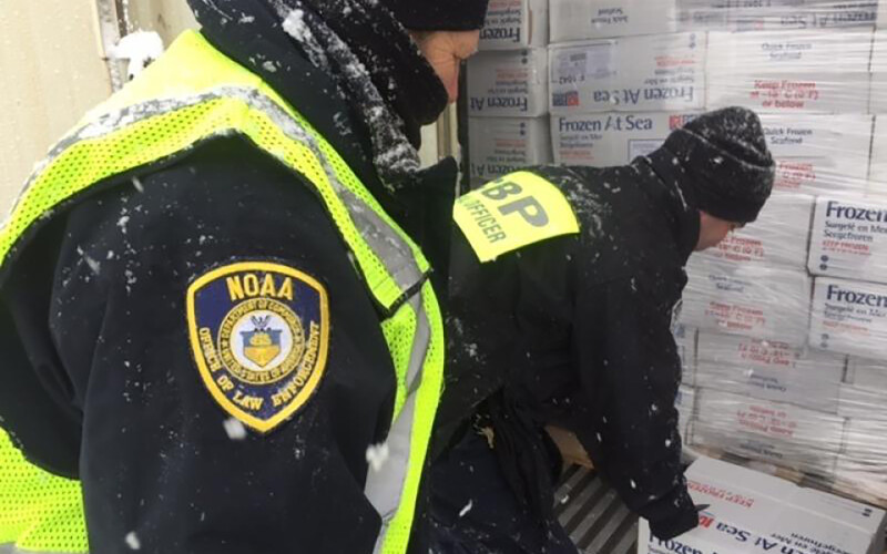 A photo of NOAA officers enforcing SIMP.