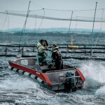 A boat outside of one of Måsøval's salmon net pens.