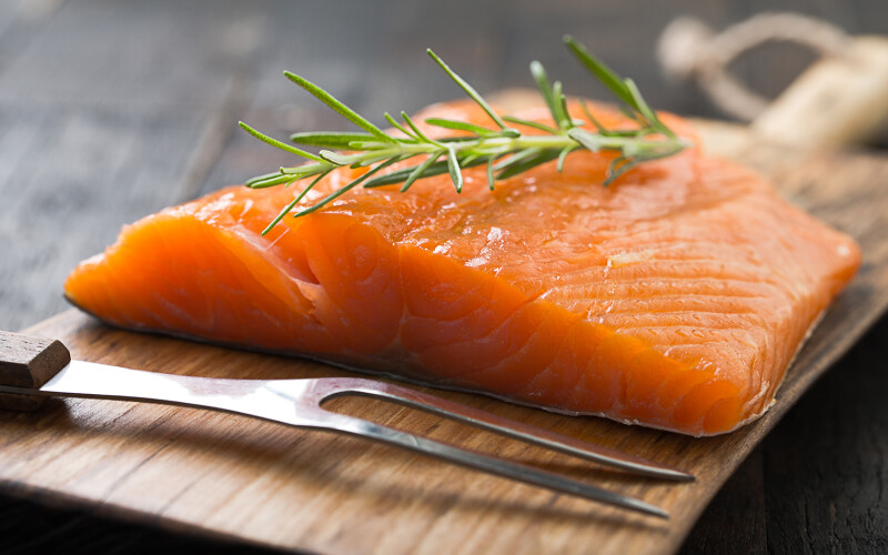 Norwegian salmon fillet with a garnish on top.