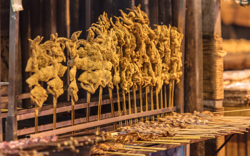 Fried squid skewers at a market in China