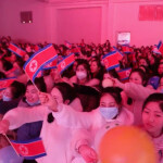 Footage from Donggang Jinhui’s annual meeting in February 2023, posted on social media, showing employees waving miniature North Korean flags.