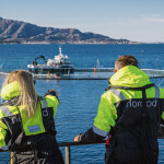 Two people standing on a Norcod net pen