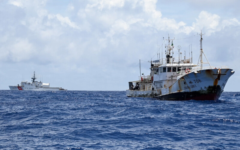 U.S. Coast Guard vessel Cutter Harriet Lane seen in the distance of a fishing vessel in the South Pacific Ocean