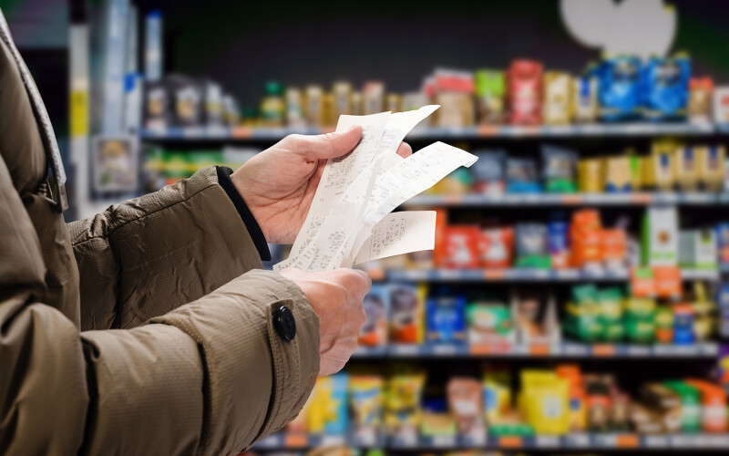 A shopper looking at receipts