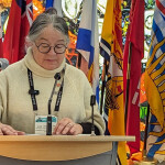 Canadian Minister of Fisheries Diane Lebouthillier speaking at a podium, with flags of the Canadian provinces behind her.
