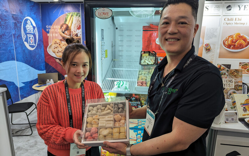 Tenyu Foods Co. employees showing off the company's fish cake products at their booth at Seafood Expo North America