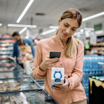 A woman scanning a QR code at a grocery store