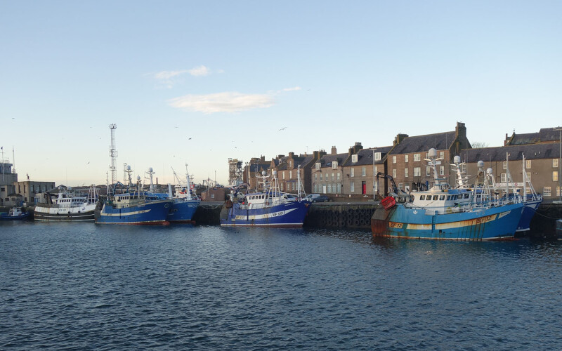 Fishing boats along the quay in the harbor of Peterhead, Scotland