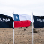 Two Blumar flags flanking a Chilean flag