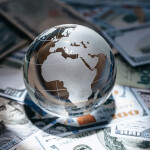 A stock photo of a glass globe on a pile of money