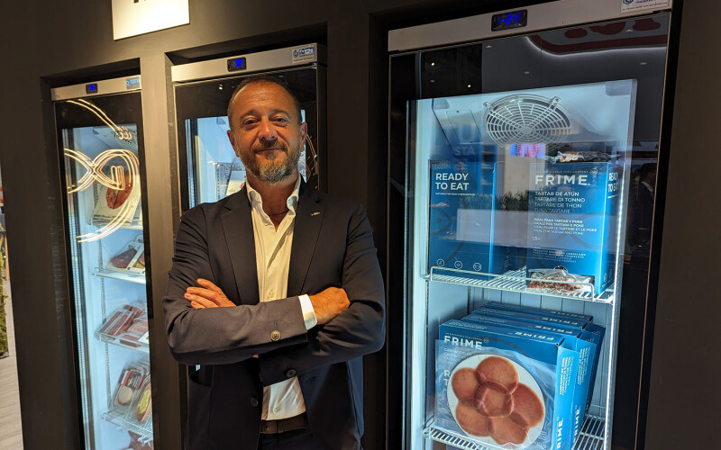 Frime President and Owner Salvador Ramon in front of some of the company's tuna products