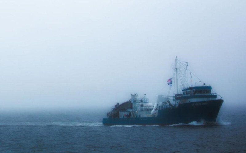 A ship operated by Ocean Harvesters sailing in the fog.