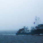 A ship operated by Ocean Harvesters sailing in the fog.