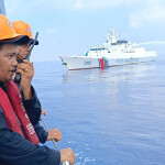Members of the Philippine Coast Guard interacting with the China Coast Guard in the South China Sea